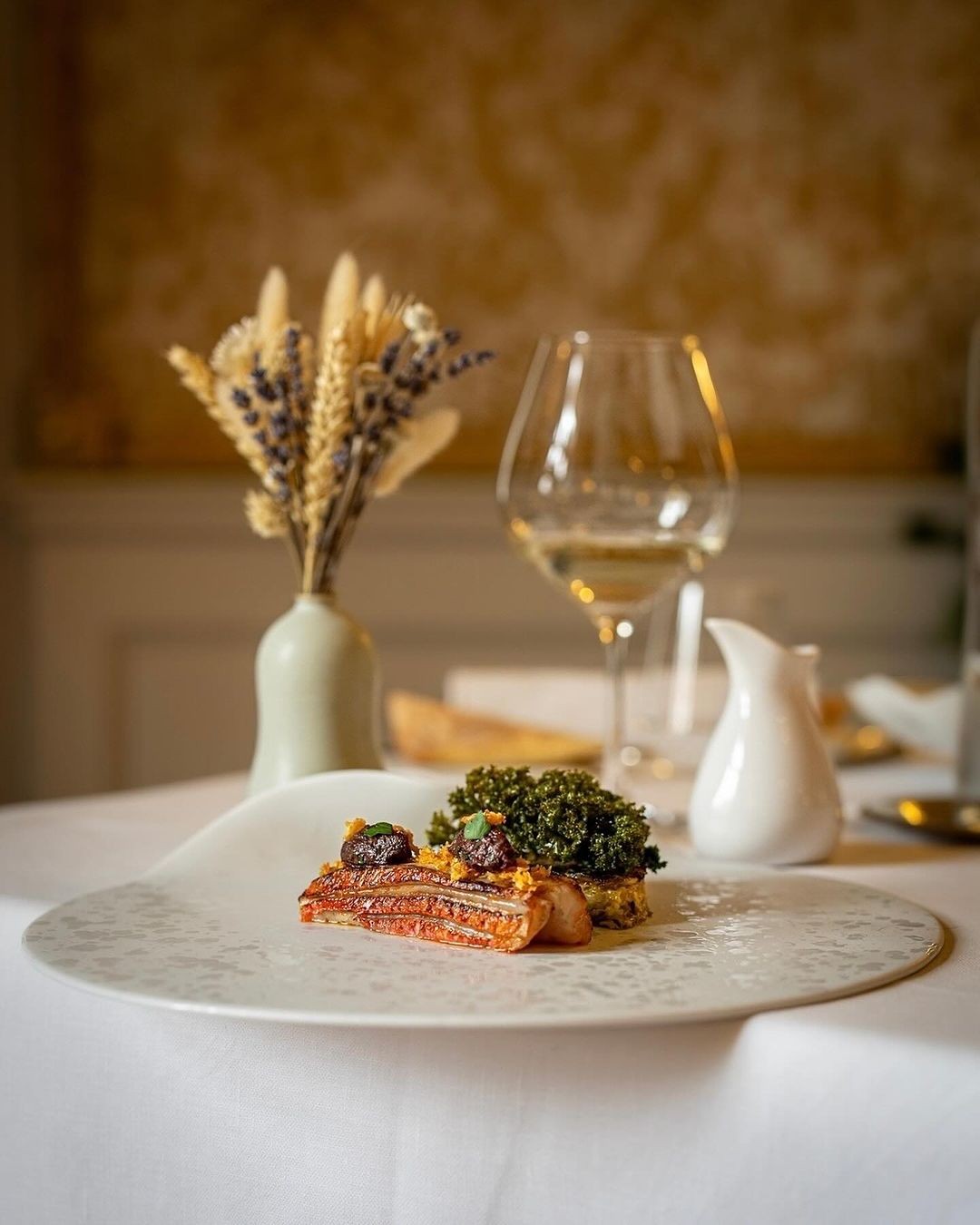 Plat gastronomique avec verre de vin et décoration